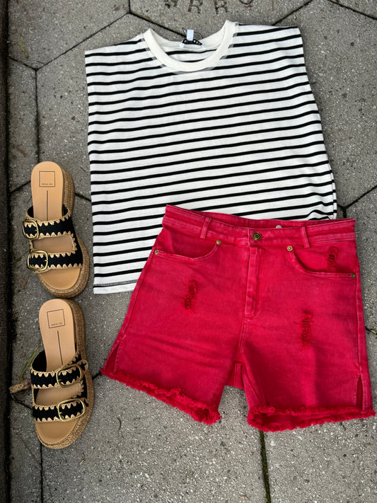 Red distressed denim shorts